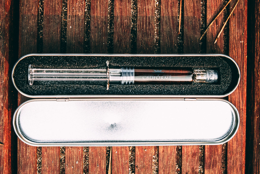 CBD oil applicator in a metal tin