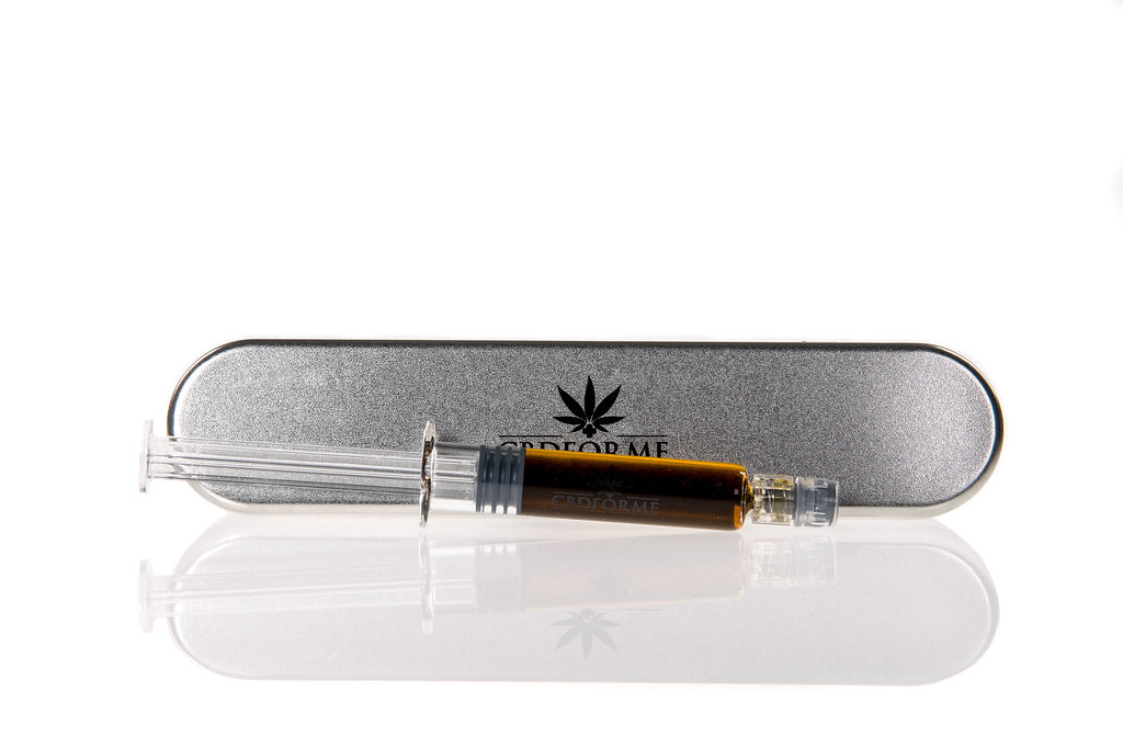 CBD oil applicator in a metal tin